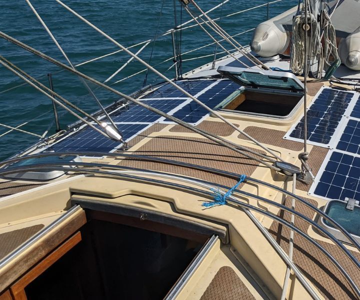 A sailboat with solar panels on the deck