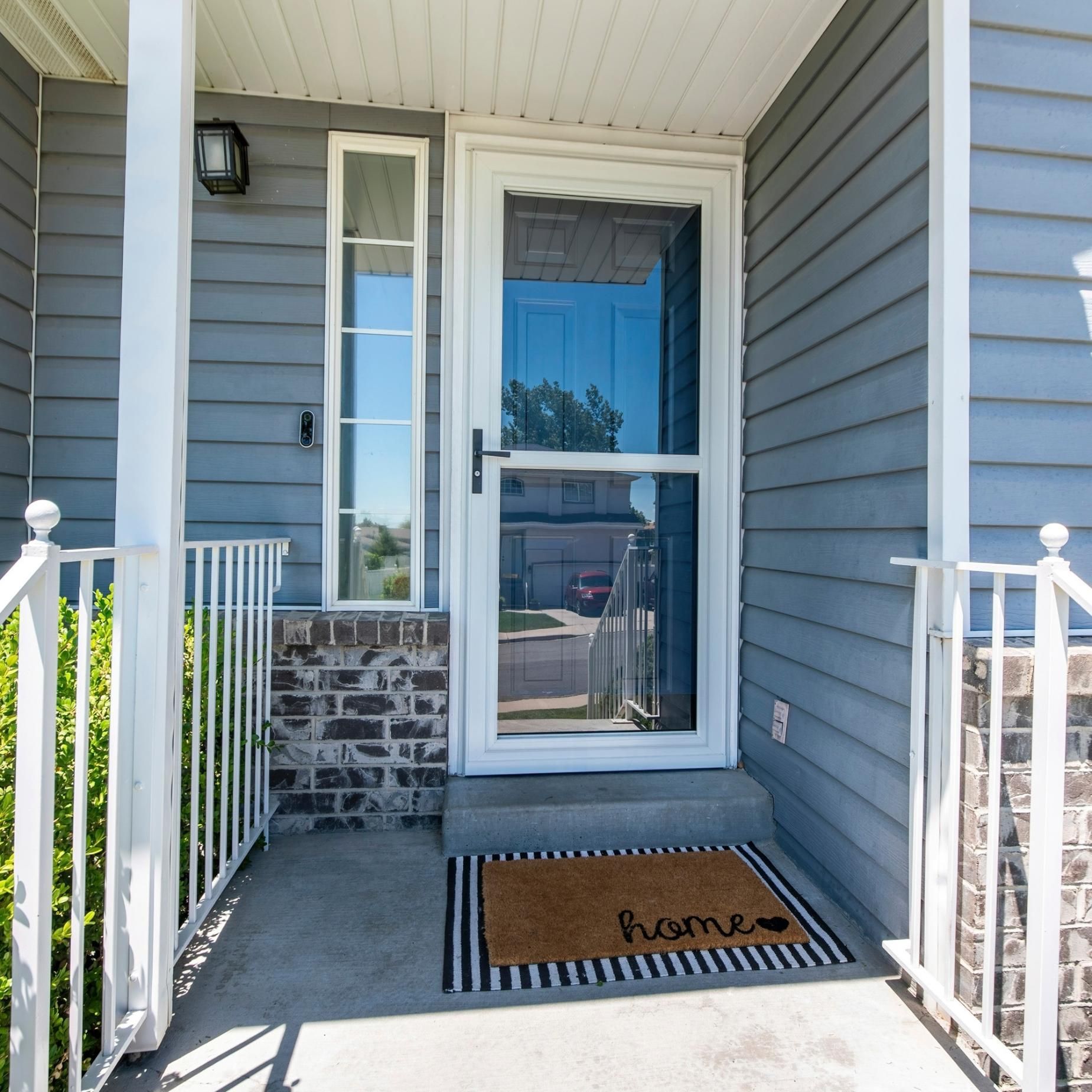 The front door of a house has a welcome mat on it.