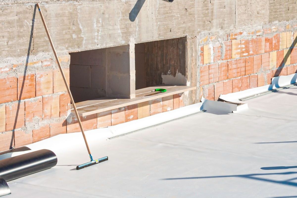 A white roof is being installed on a building under construction.
