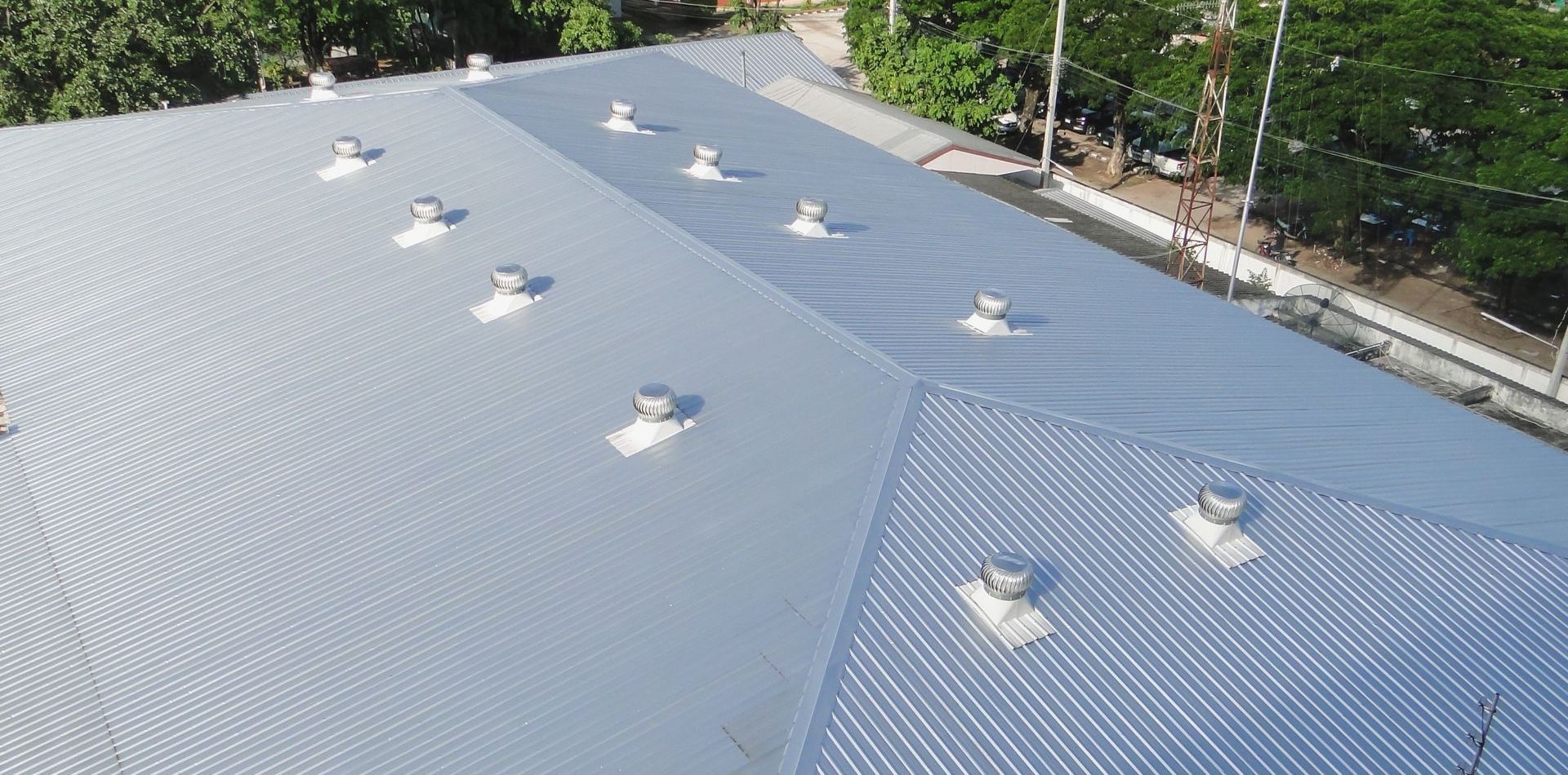 An aerial view of a roof with a lot of vents on it.