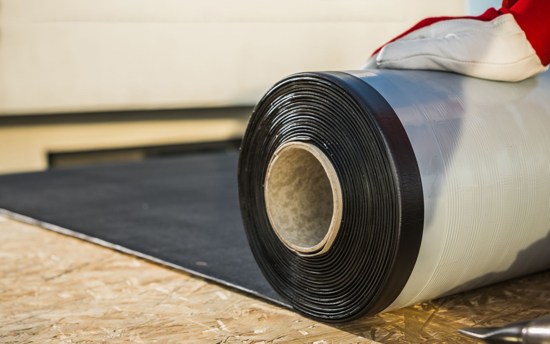 a roll of black rubber sitting on a wooden surface