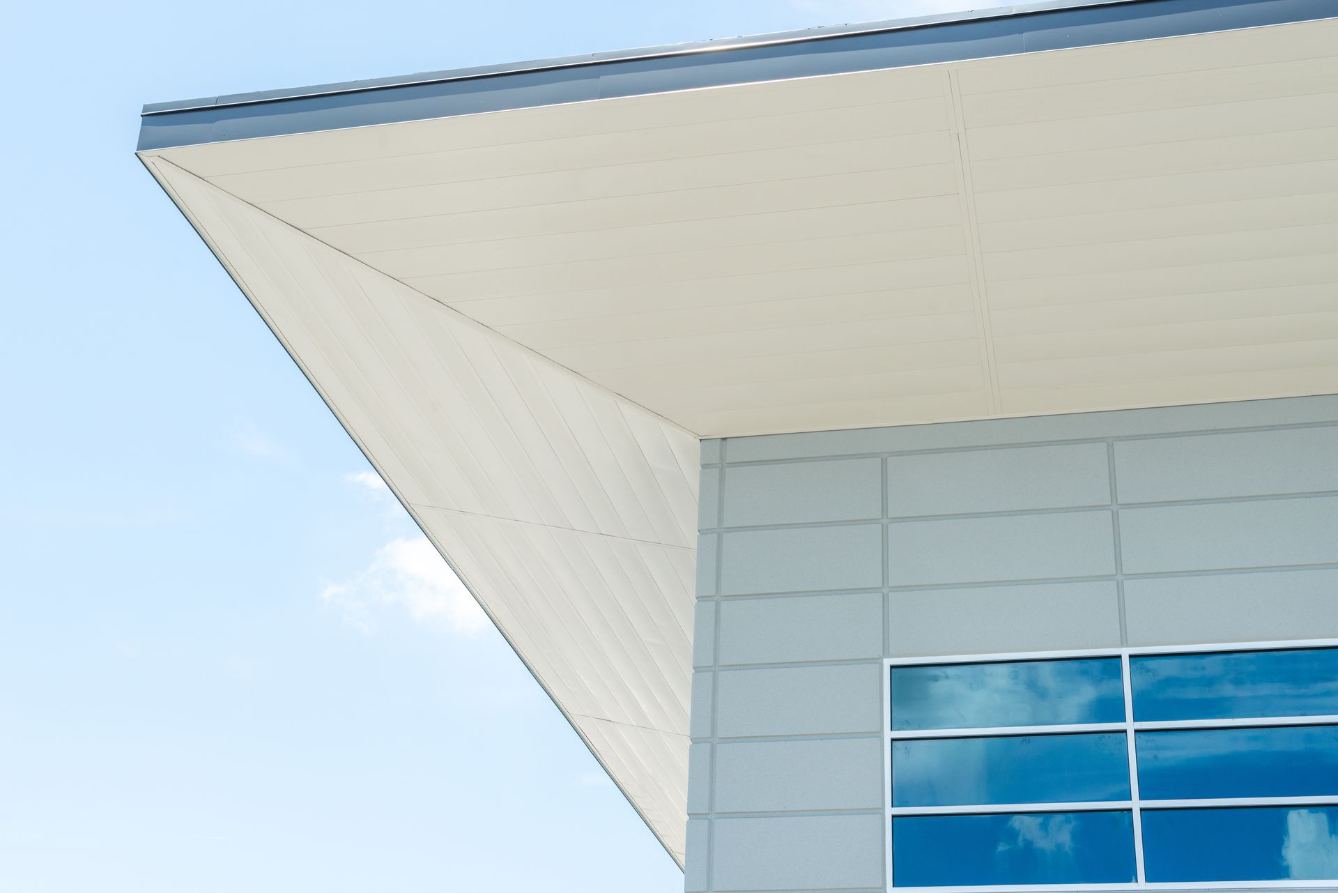 The roof of a building with a blue sky in the background