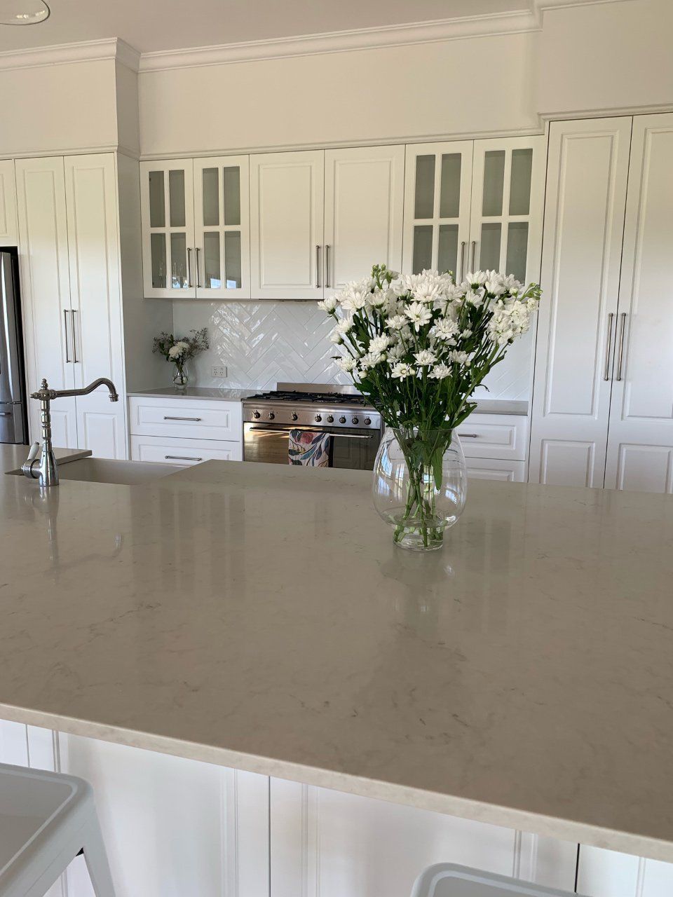 A Kitchen Counter With A Vase Of Flowers On It — Gavin Cummings Kitchens in Dubbo, NSW