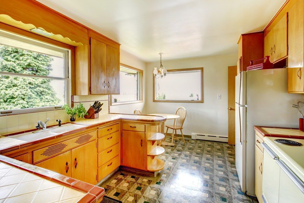 A Kitchen With Wooden Cabinets, a Refrigerator, a Sink, and a Window — Gavin Cummings Kitchens in Dubbo, NSW