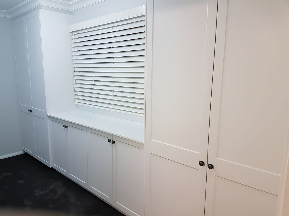A Room With White Cabinets And A Window With Blinds — Gavin Cummings Kitchens in Dubbo, NSW