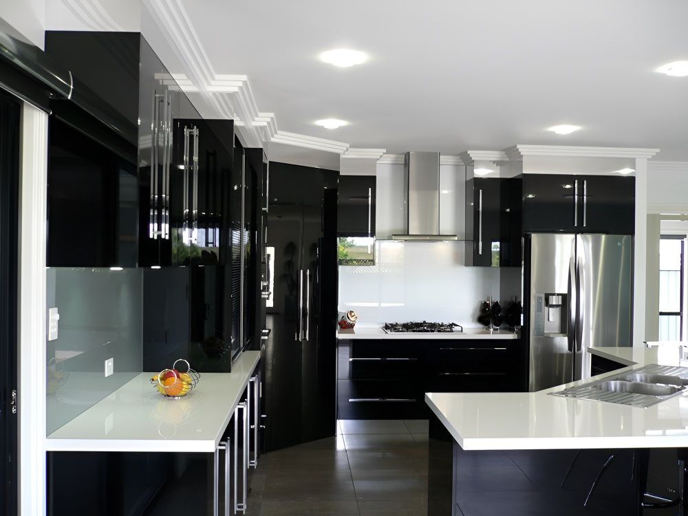 A Kitchen With Black Cabinets And White Counter Tops — Gavin Cummings Kitchens in Dubbo, NSW