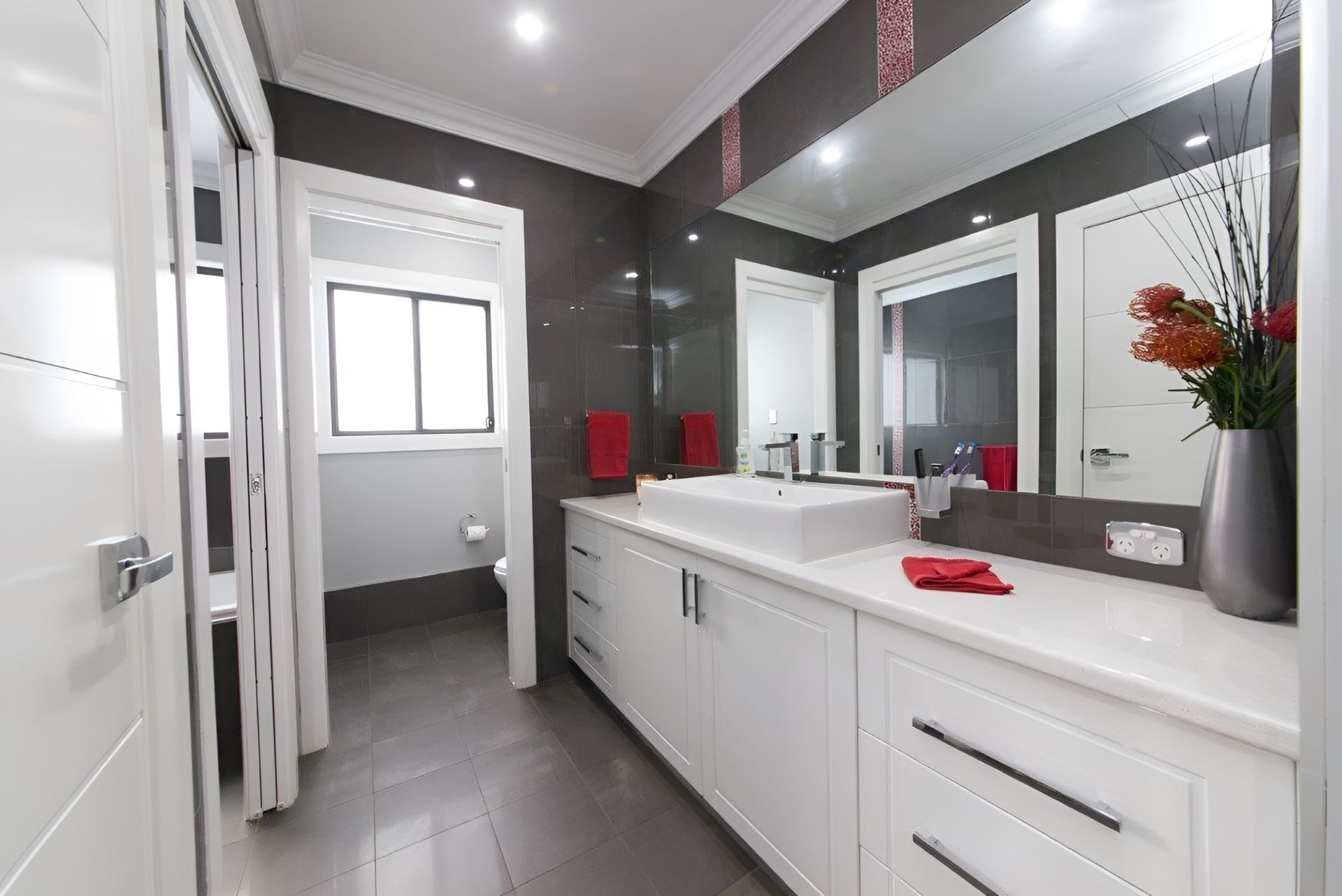 A Bathroom With A Sink, Mirror, And Cabinets — Gavin Cummings Kitchens in Gilgandra, NSW