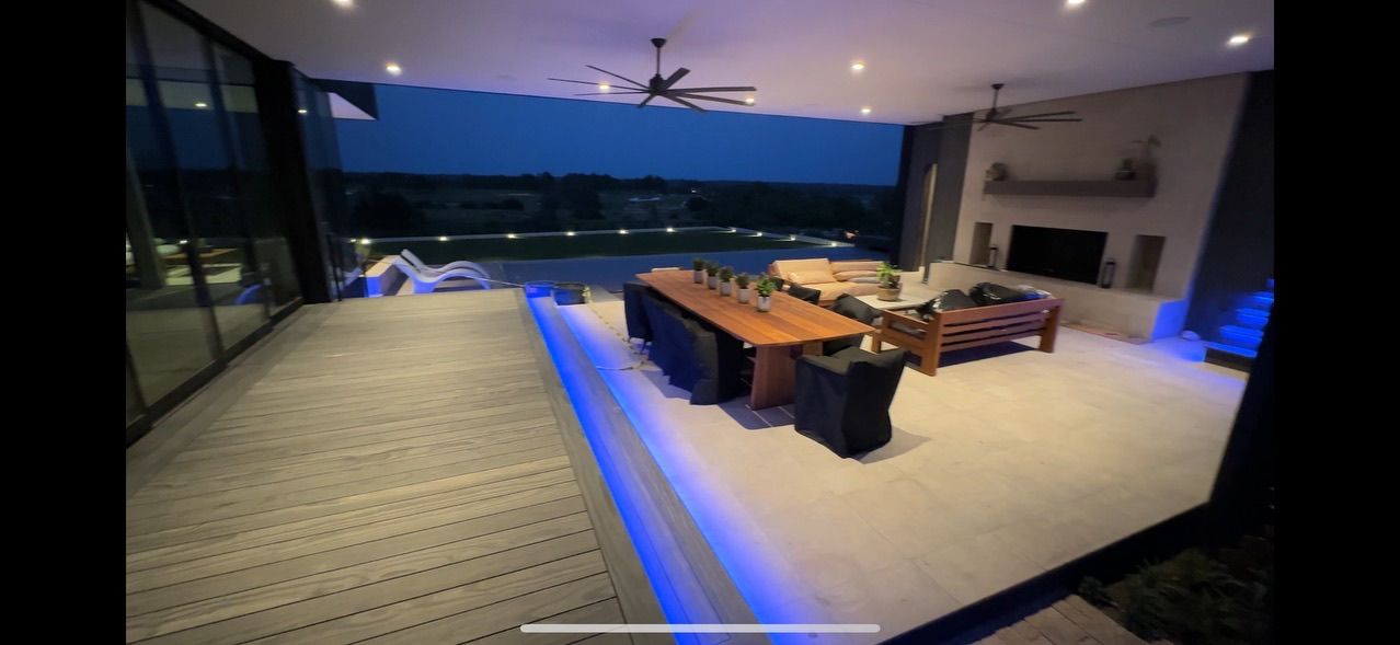 A living room with a table , chairs , and a television.