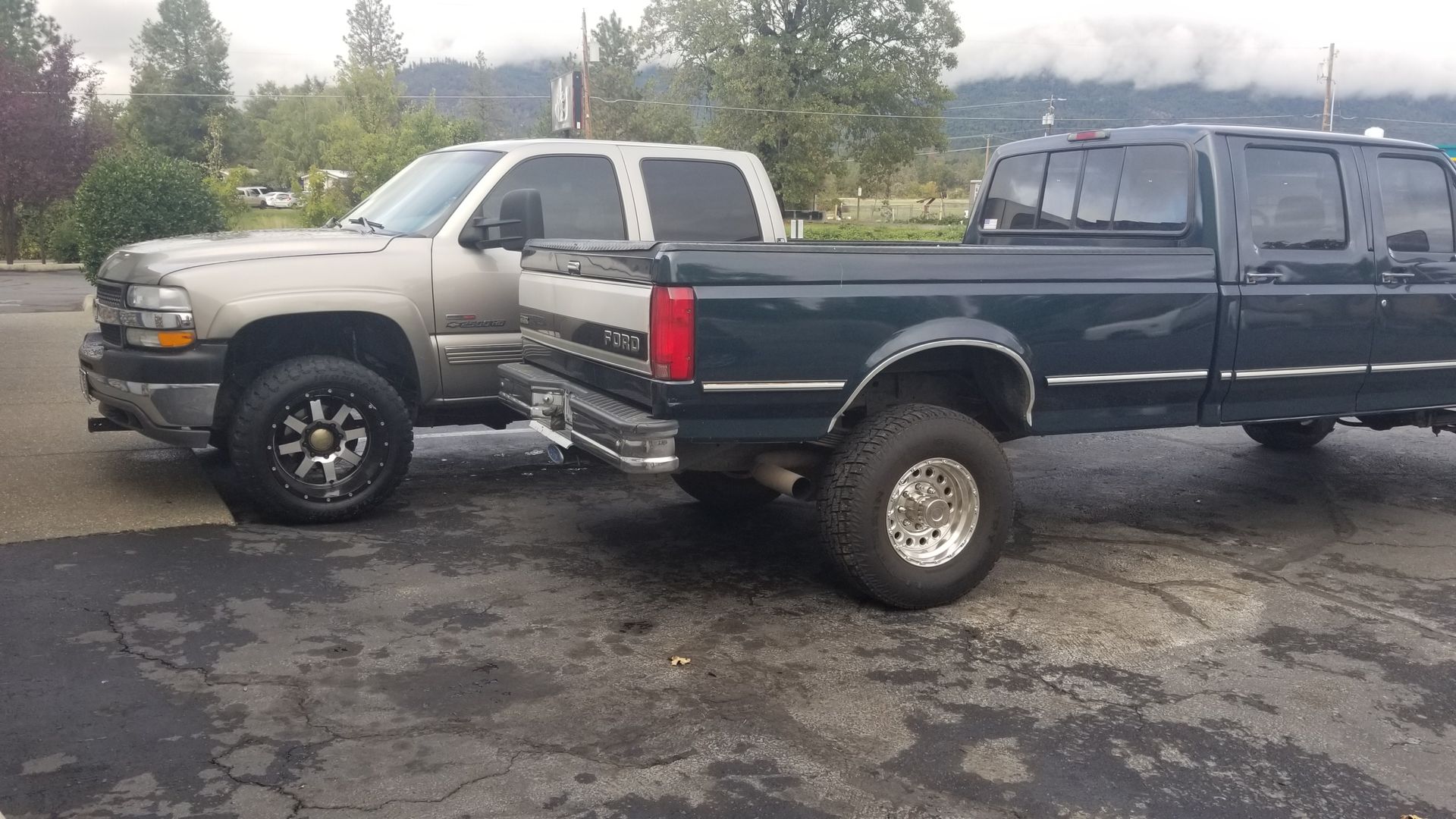 Two trucks are parked next to each other in a parking lot.