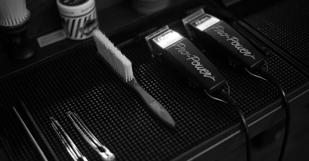 A black and white photo of a barber 's tools on a counter.