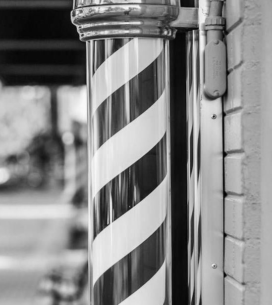 A black and white photo of a barber pole.