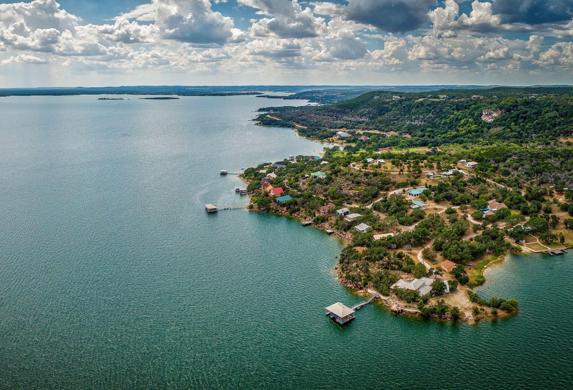 An aerial view of a large body of water with a small island in the middle.