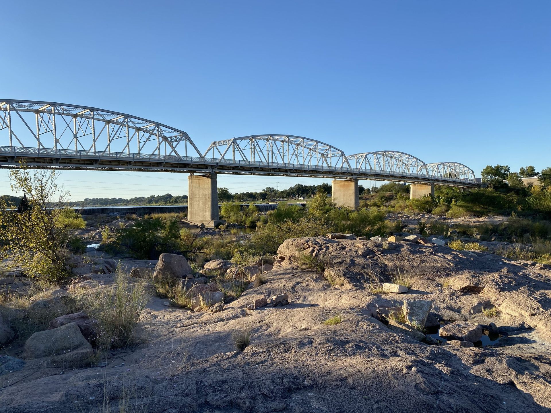 A bridge over a river with a blue sky in the background