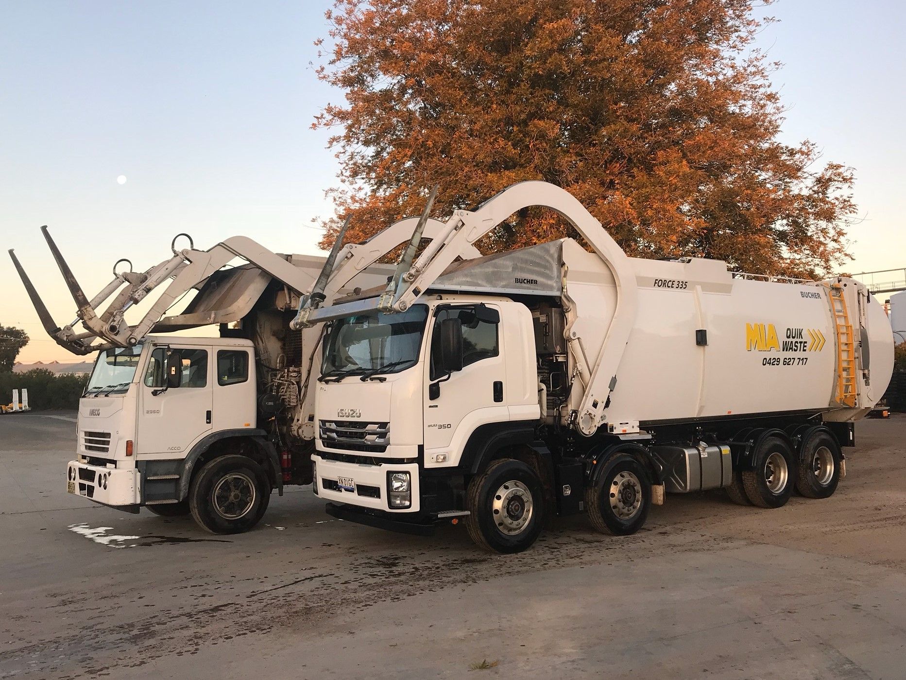 Front lift trucks lined up at depot – MIA Quik Waste Griffith NSW bin hire service