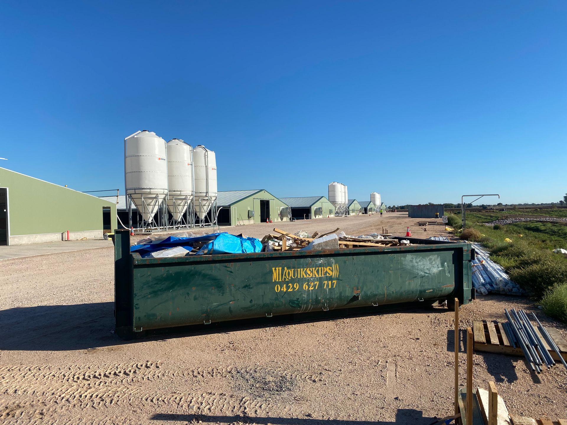 Long hook bin beside farm shed – skip hire for rural waste Griffith NSW