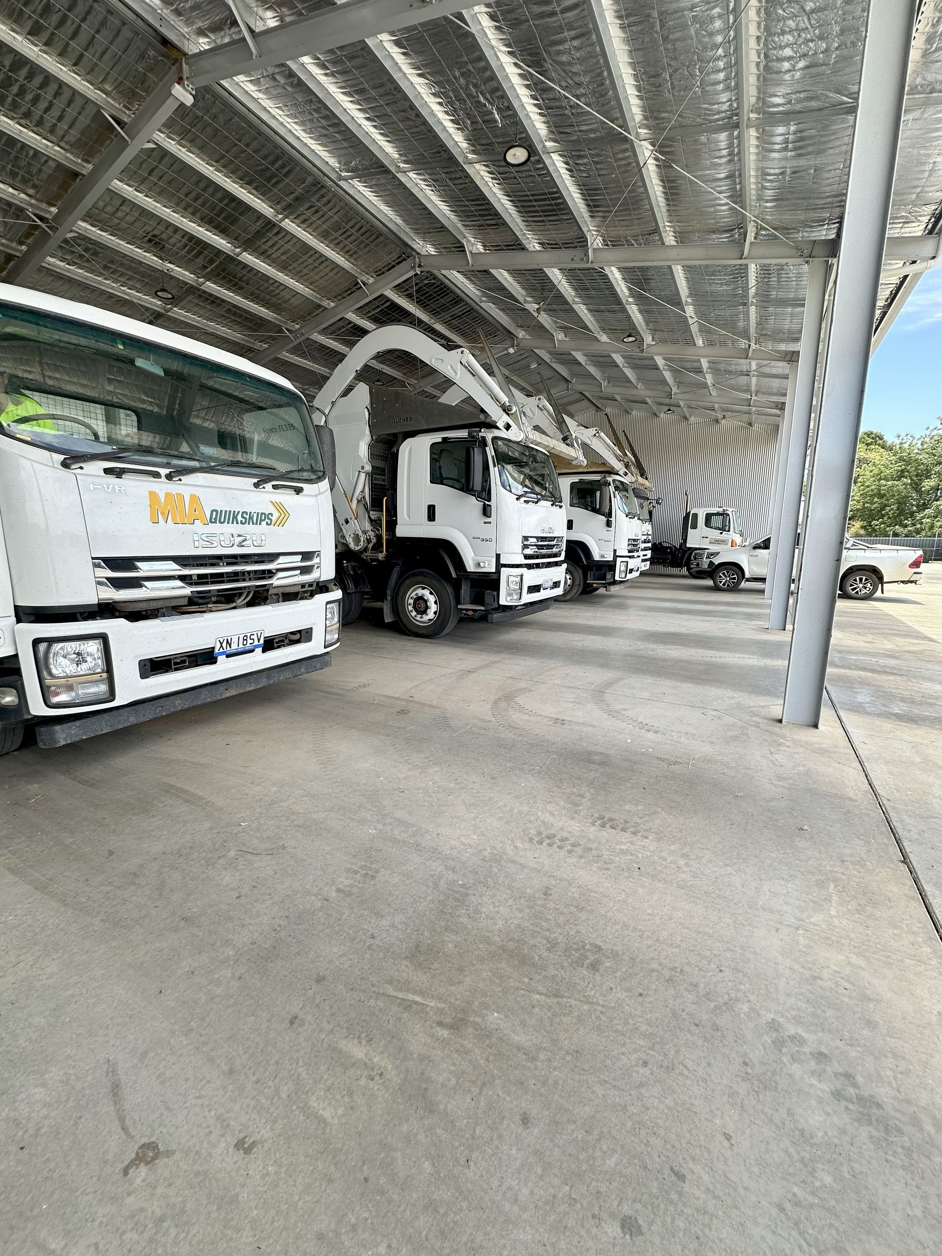MIA Quik Waste trucks in Griffith depot – front lift and skip bin fleet
