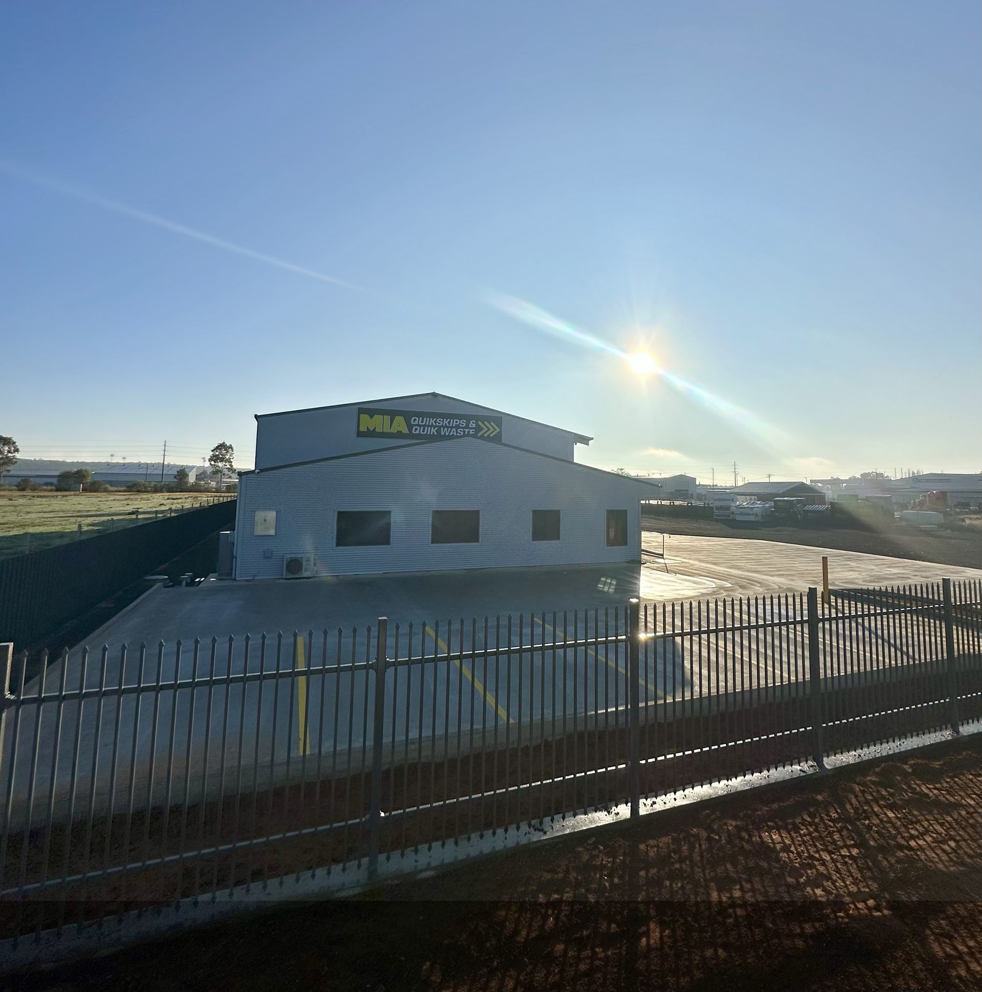 MIA Quikskips depot with signage at sunrise – skip bin hire Griffith NSW – family-owned business