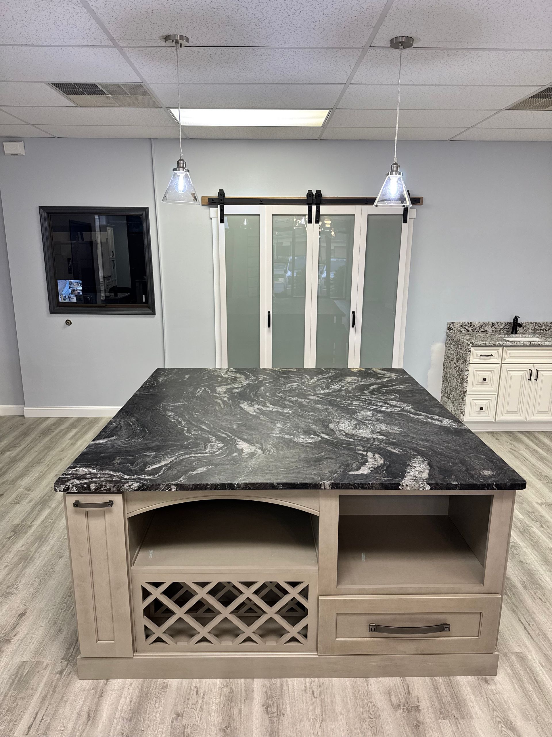 Kitchen island with black granite countertop and storage, in a modern interior.