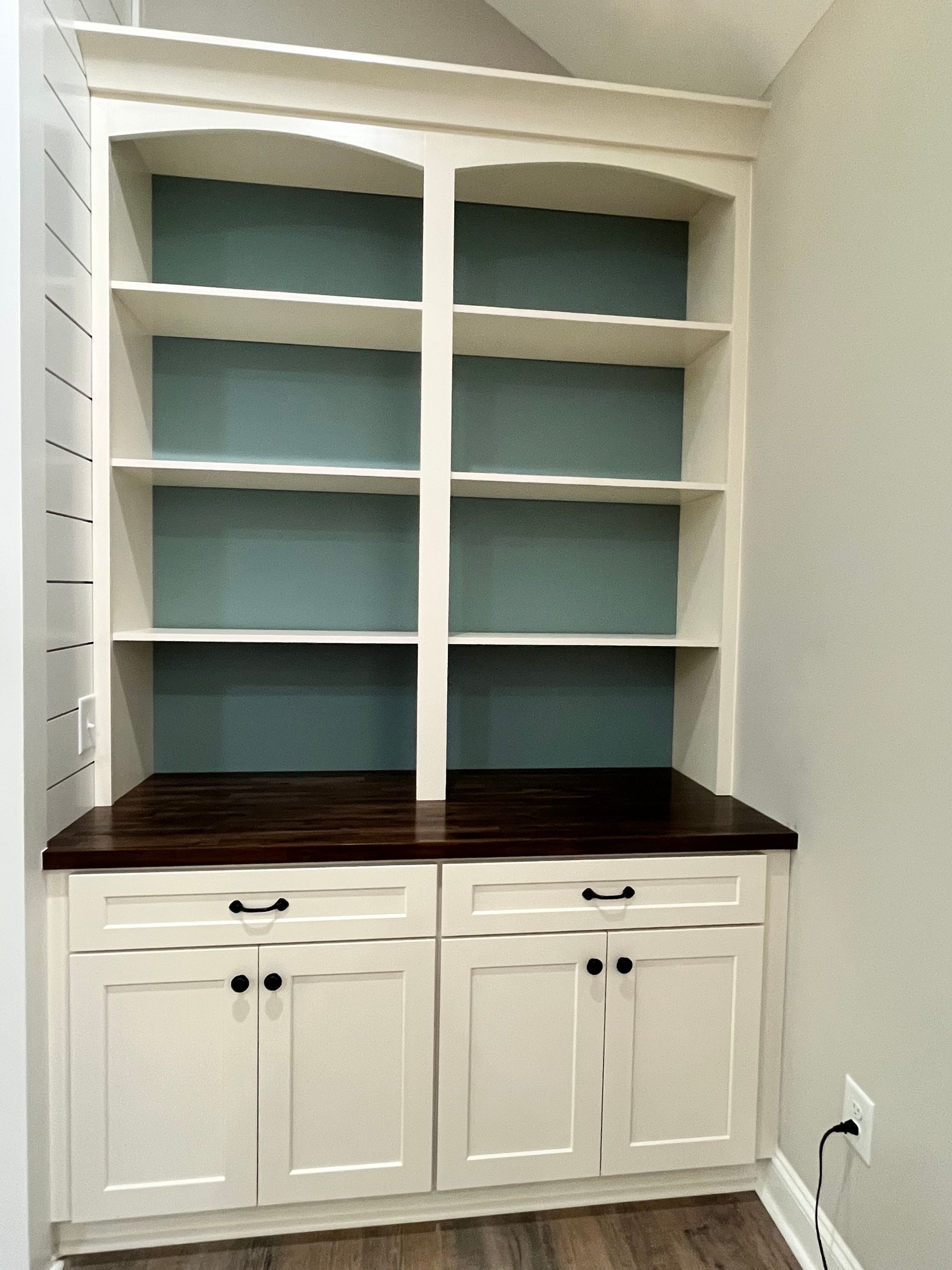Kitchen with wood cabinets, stainless steel oven, stone backsplash, and granite countertops.