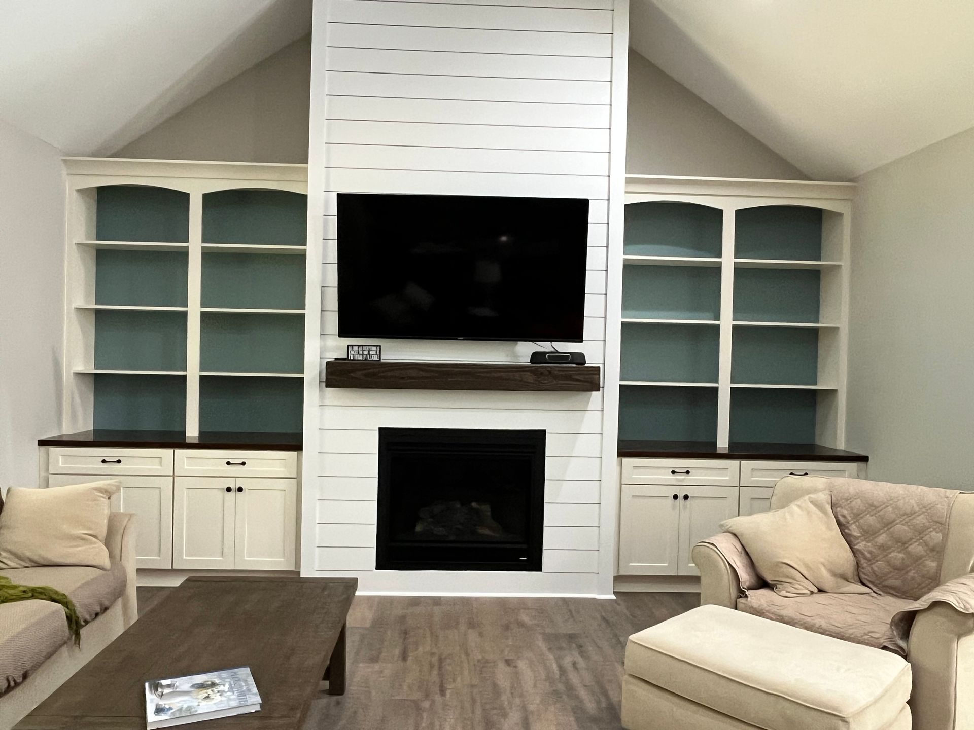 Kitchen with white cabinets, speckled countertop, stainless steel sink and appliances, and dark tile backsplash.