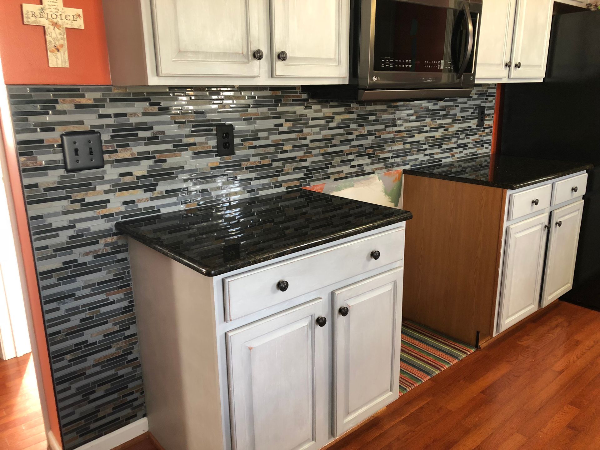 U-shaped desk with granite top, black office chair, and guest chair in an office setting.