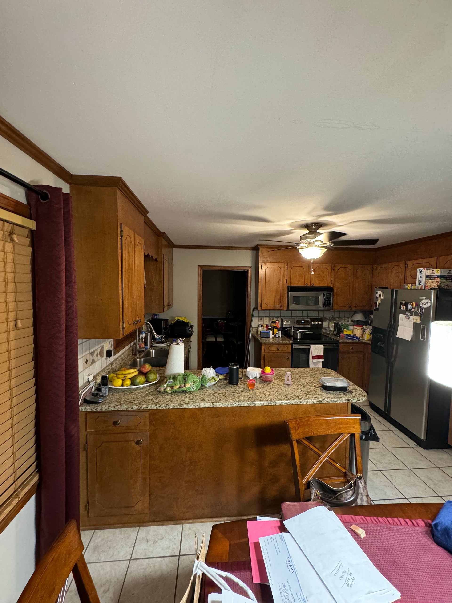 Kitchen with brown cabinets, granite countertops, and stainless steel appliances.