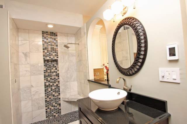 Bathroom Remodeling — Bathroom with Sink and Round Mirror in Virginia Beach, VA