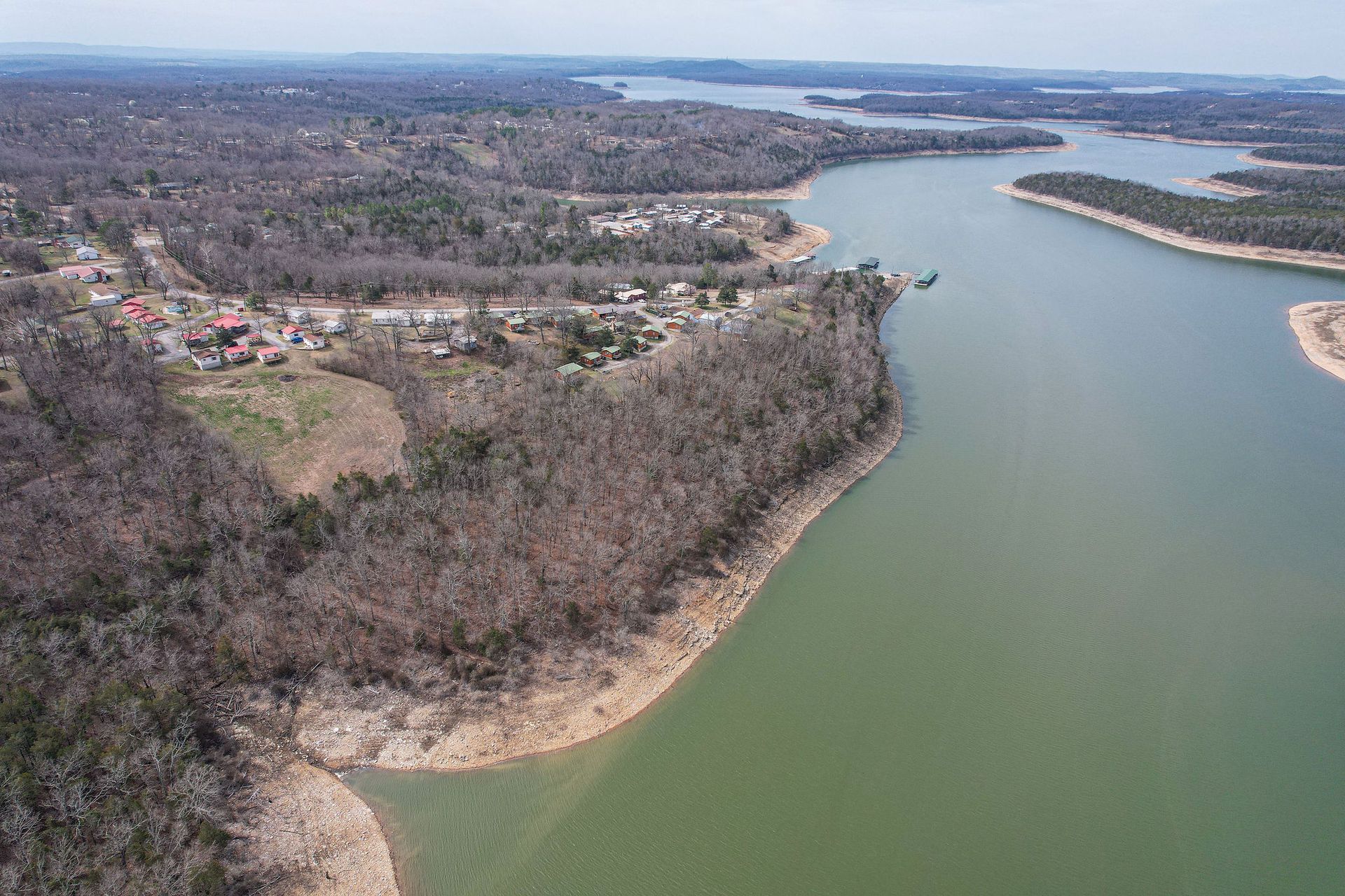 An aerial view of a large body of water surrounded by trees.