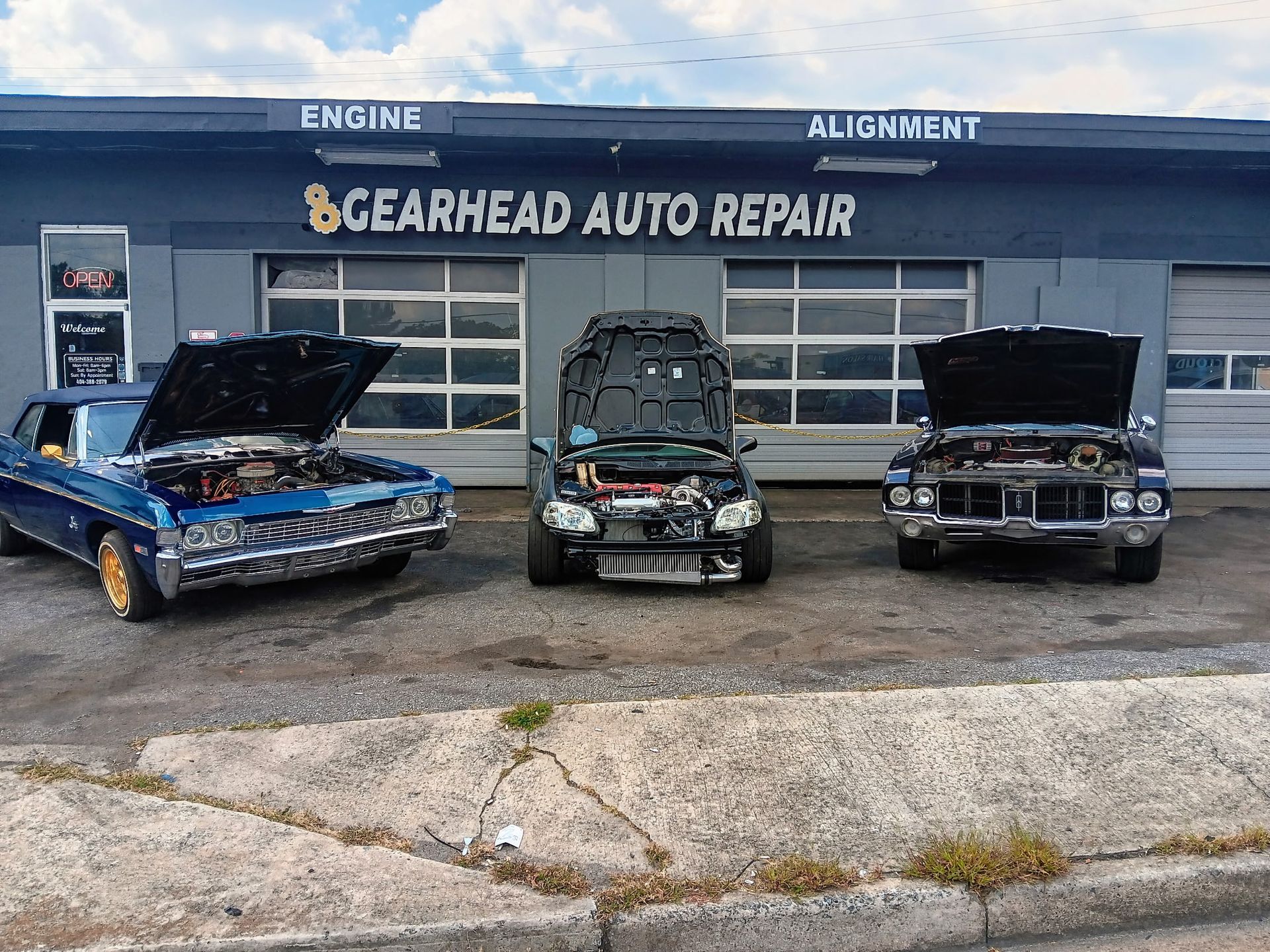 Gearhead Auto Repair shop with three cars with open hoods.