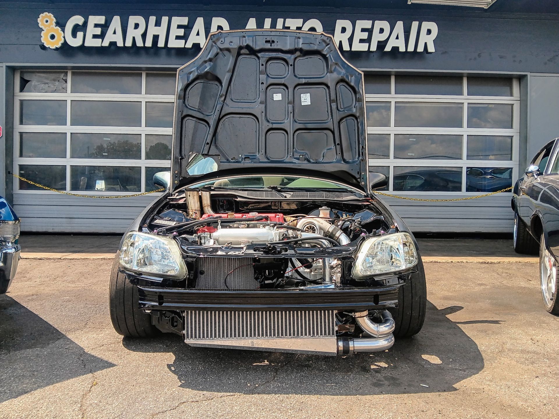 Black car with open hood at 