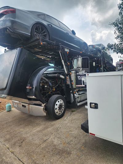 A car is sitting on top of a tow truck.