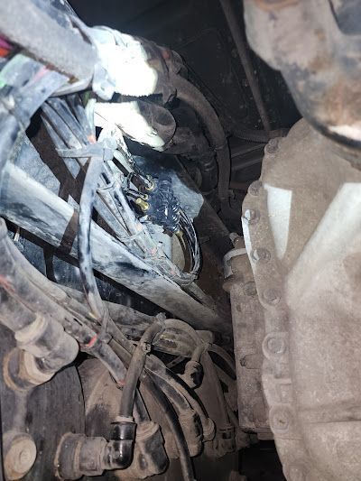 A close up of a person working on a car engine.