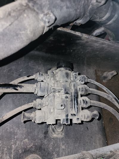 A close up of a hydraulic valve on a car