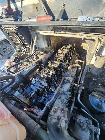 A close up of a car engine with the hood open.