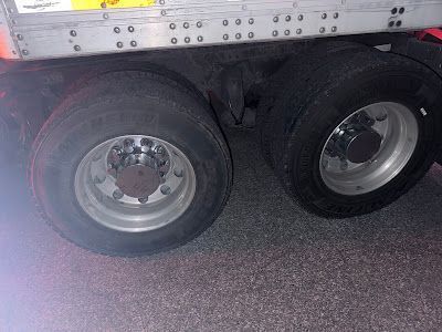 A close up of a truck 's wheels and tires.