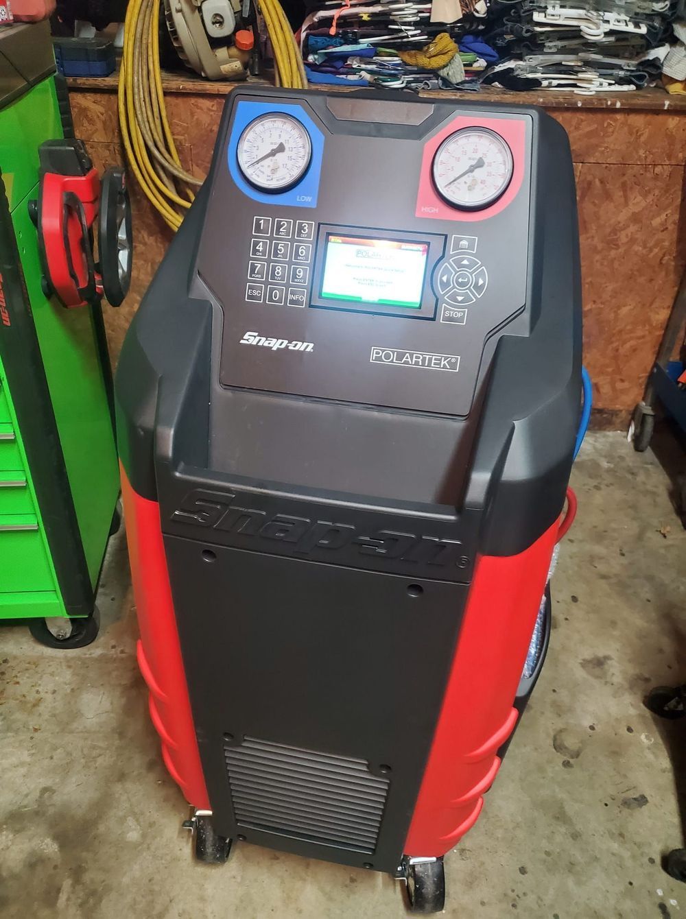 A snap on air conditioning machine is sitting in a garage.