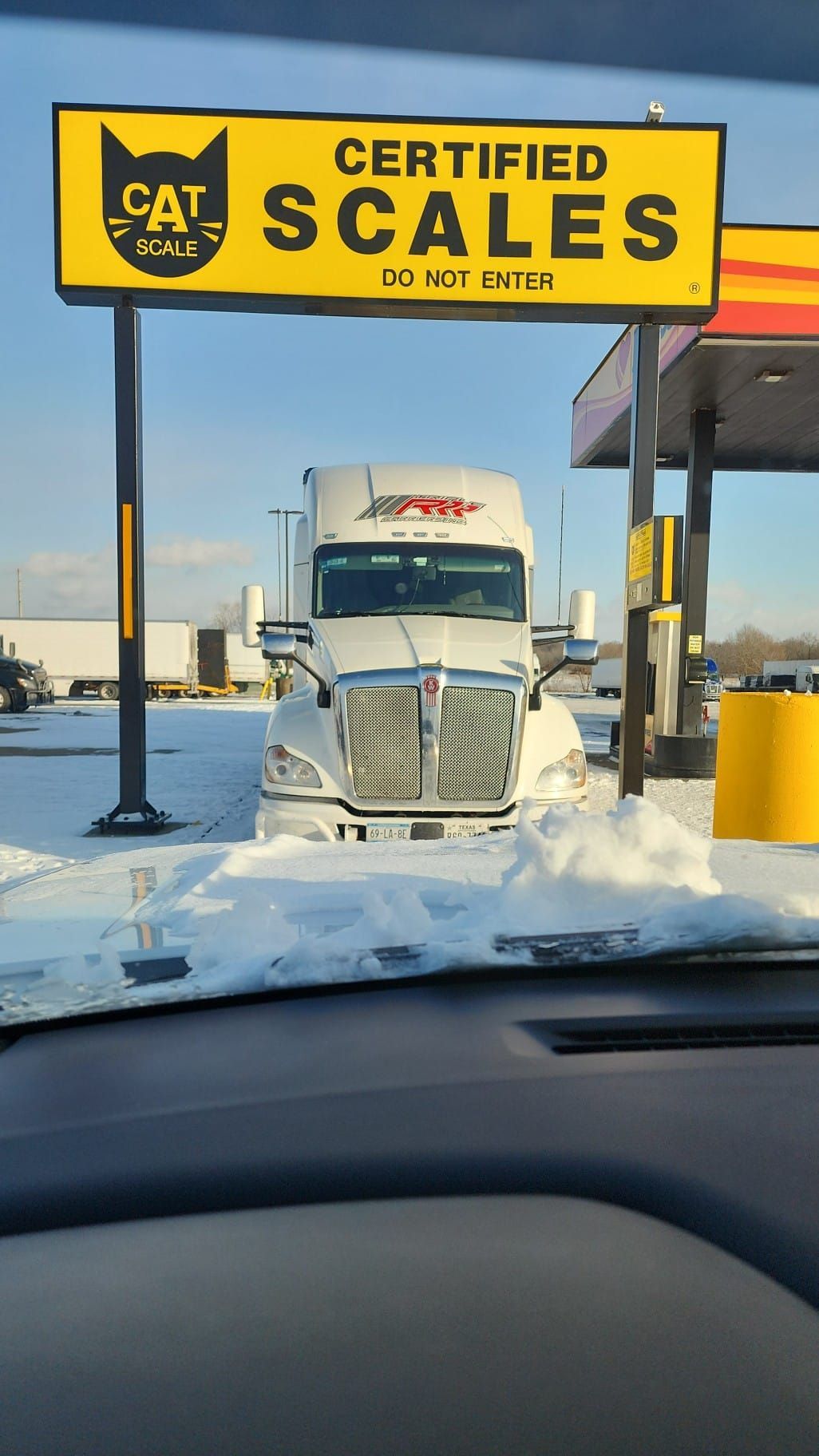 A truck is parked in front of a sign that says certified scales