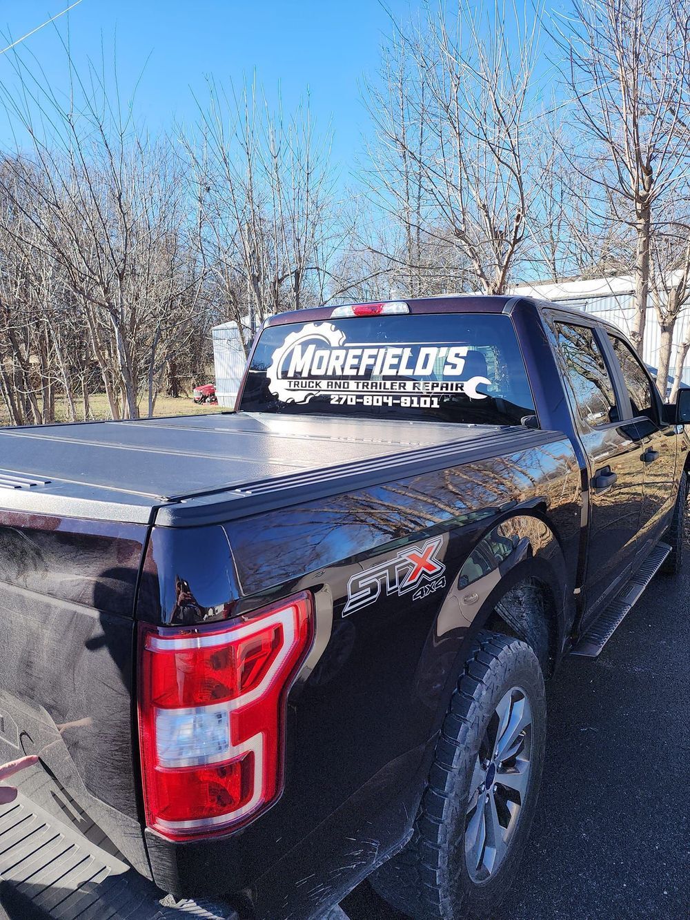 A black pickup truck is parked on the side of the road.