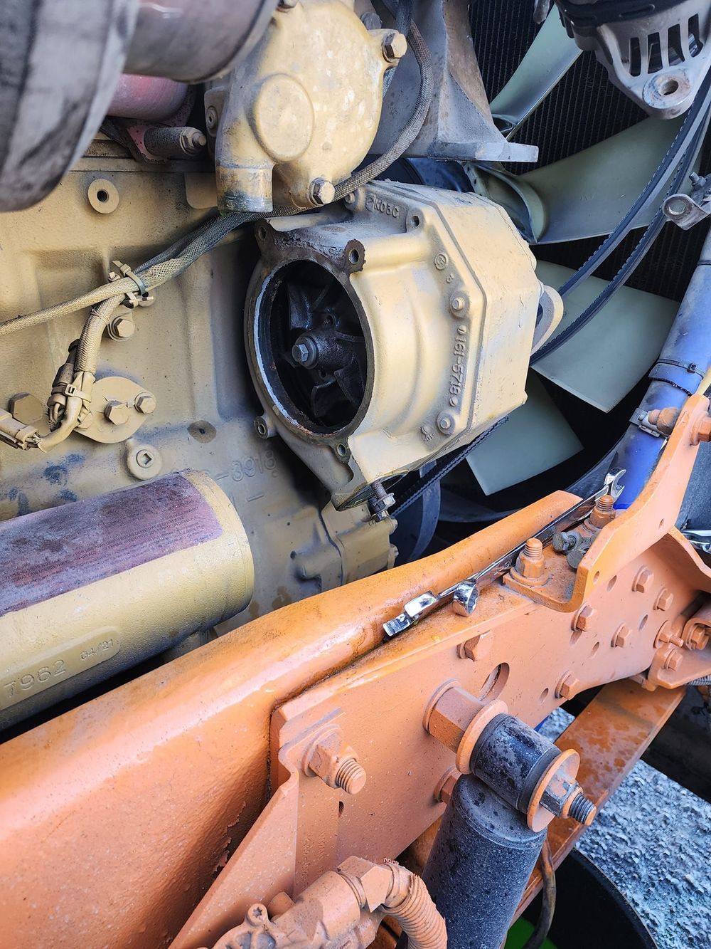 A close up of a yellow engine on a truck.