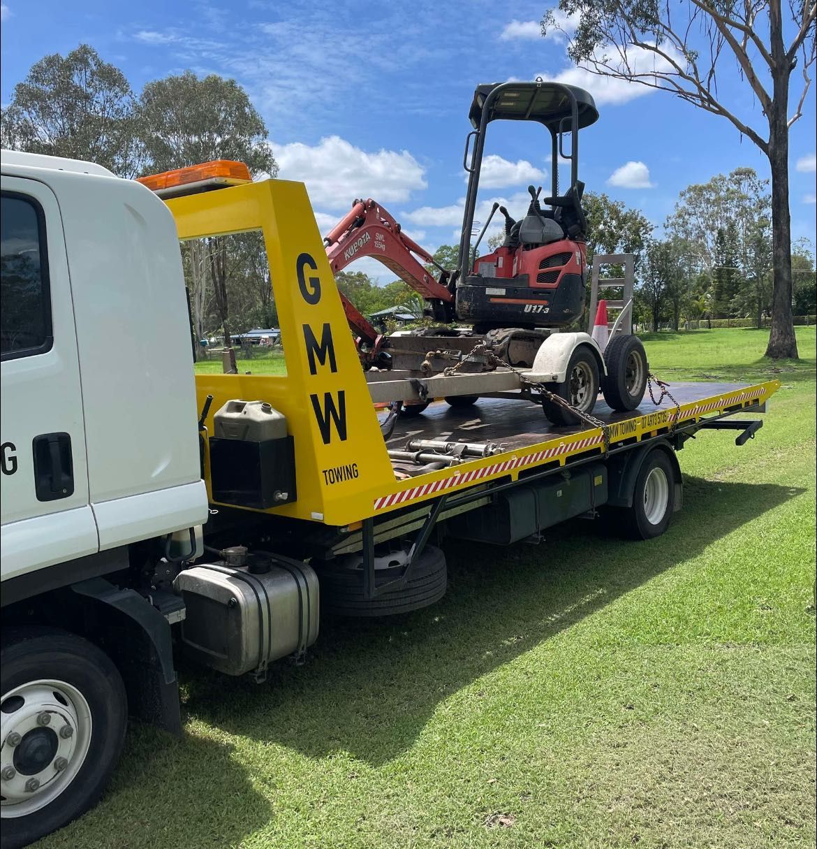White SUV being towed by a tow truck at night.