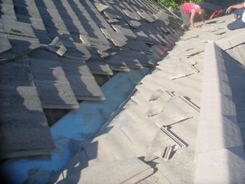 Men working on a tile roof