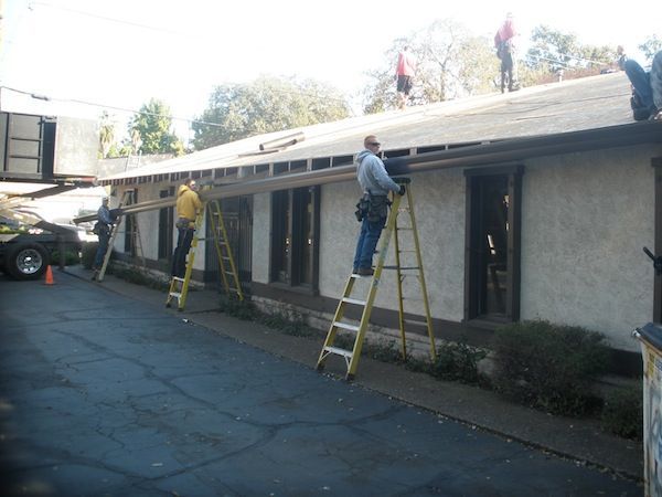 Men working on a tile roof