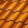A close up of a row of orange tiles on a roof.