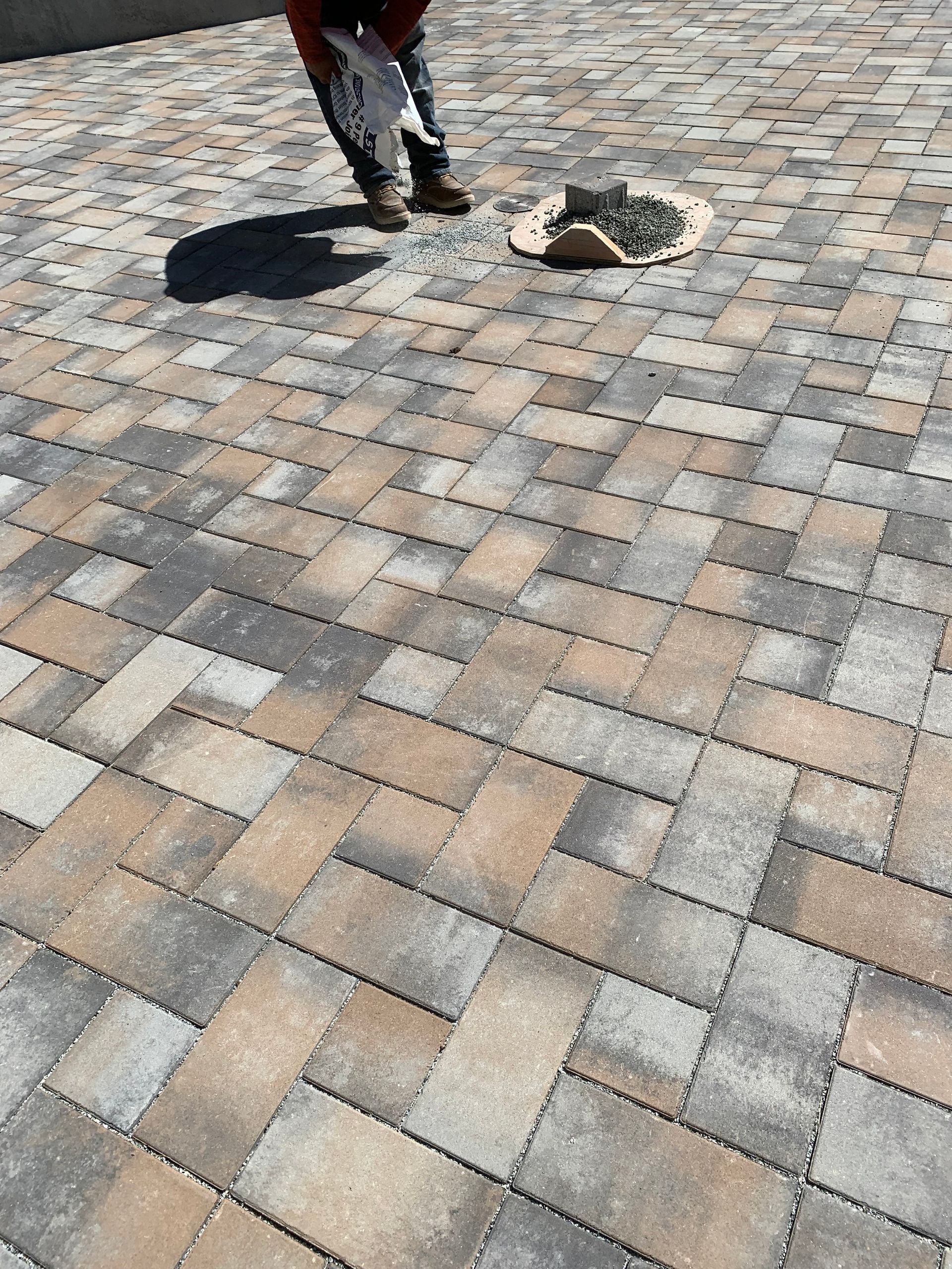 Brussel block design pavers creating an outdoor patio surface.