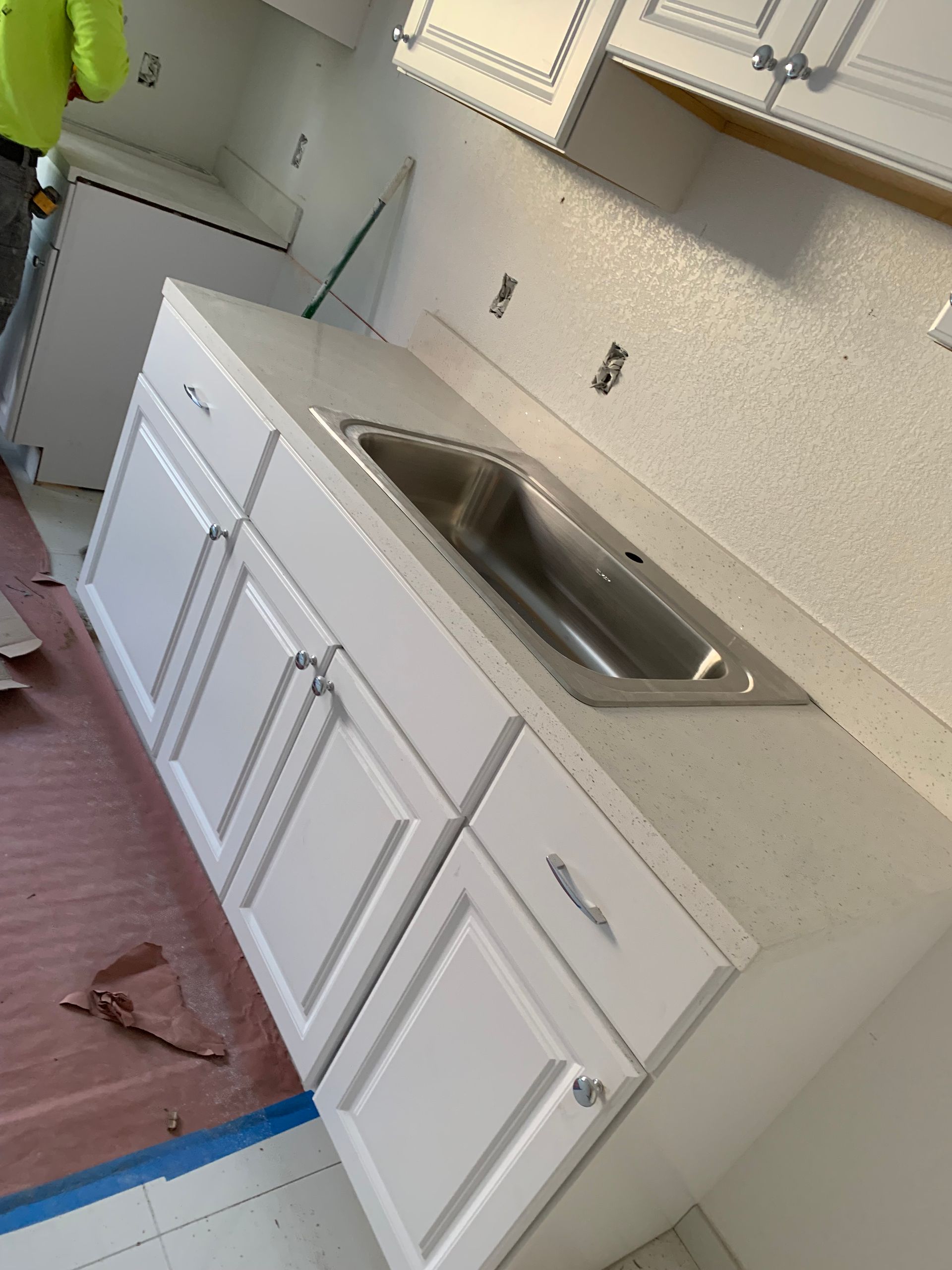 a kitchen with blue and white cabinets.