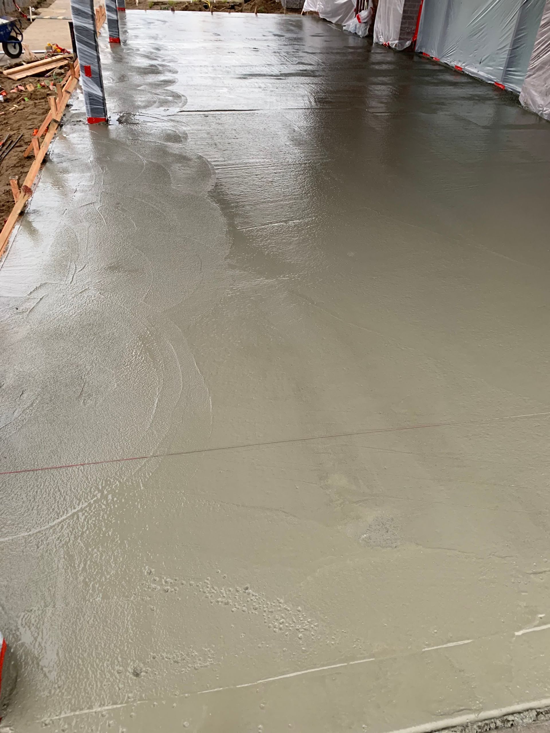 two construction workers are working on a concrete floor
