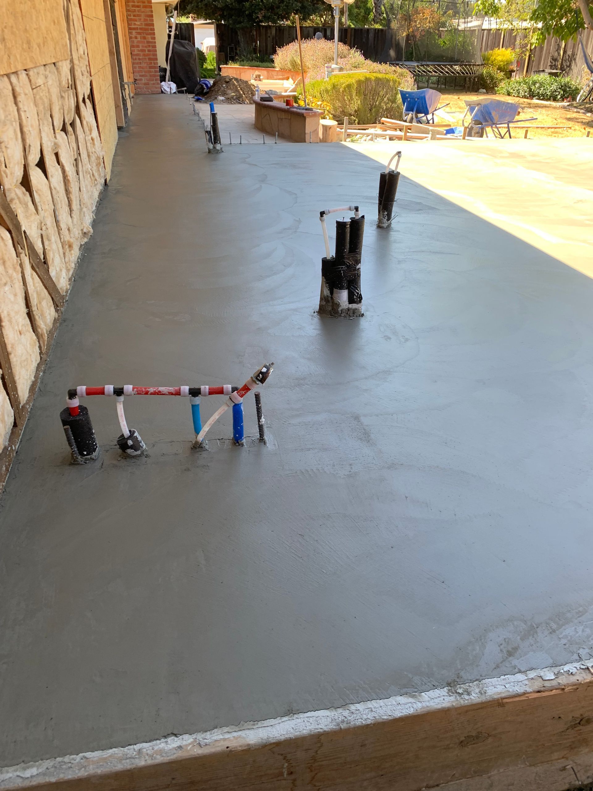 two construction workers are working on a concrete floor