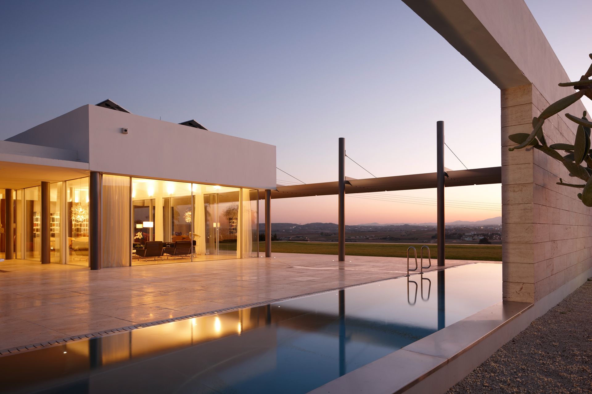 A large white house with a swimming pool in front of it