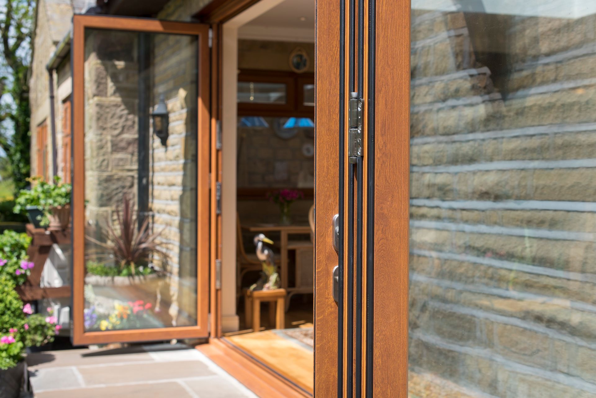 A wooden sliding glass door is open to a living room.