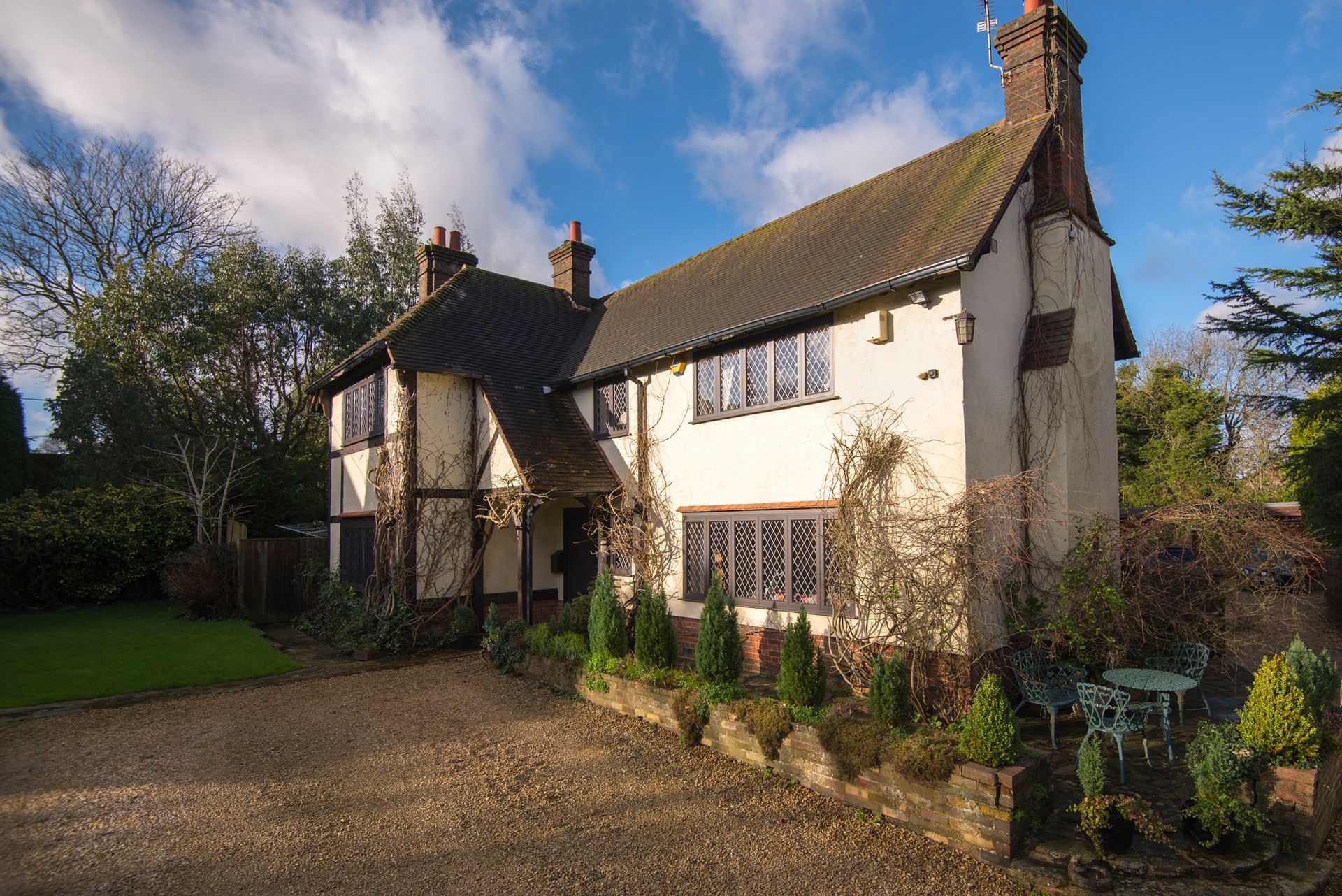 A large white house with a driveway in front of it